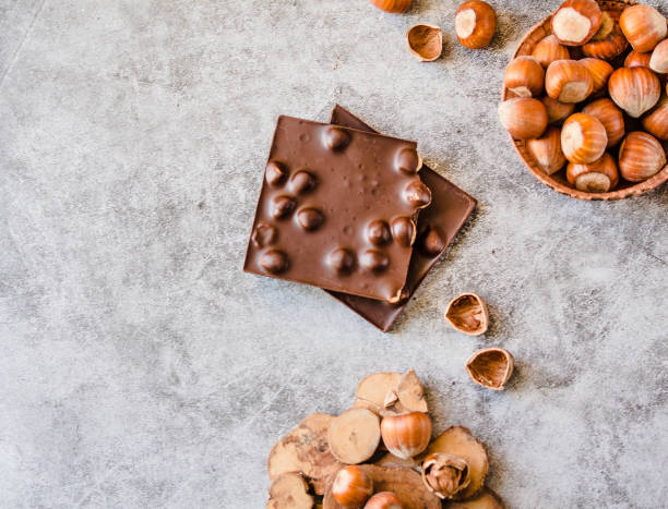 Homemade hazelnut chocolate bar. Nuts and chocolate background. Ingredients for cooking homemade chocolate sweets. Confectionery and sweets concept stock photo