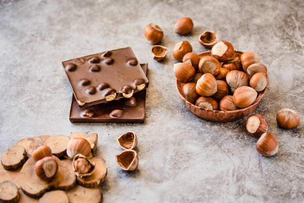 istock Homemade hazelnut chocolate bar. Nuts and chocolate background. Ingredients for cooking homemade chocolate sweets. Confectionery and sweets concept 1155606403