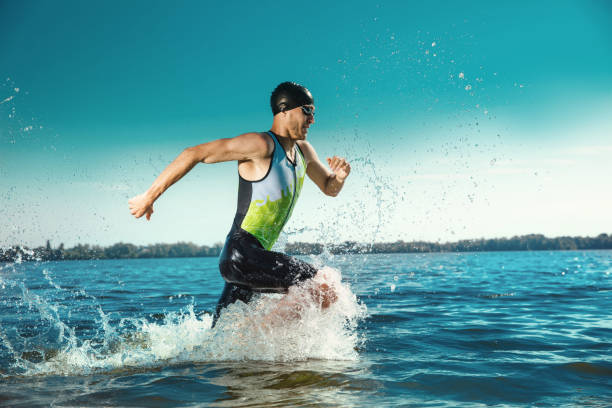 istock Professional triathlete swimming in river's open water 1155607652