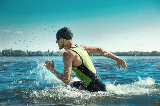 istock Professional triathlete swimming in river's open water 1155607656
