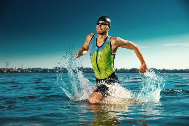 istock Professional triathlete swimming in river's open water 1155607657