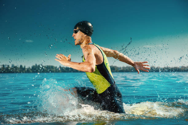 istock Professional triathlete swimming in river's open water 1155607658