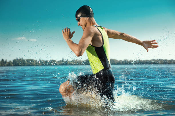 istock Professional triathlete swimming in river's open water 1155607663