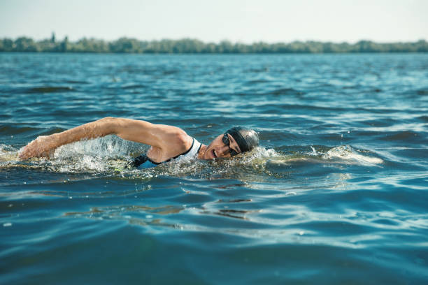 istock Professional triathlete swimming in river's open water 1155607666