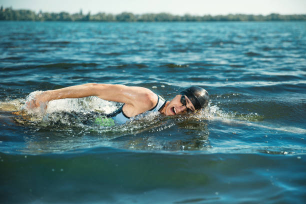 istock Professional triathlete swimming in river's open water 1155607678