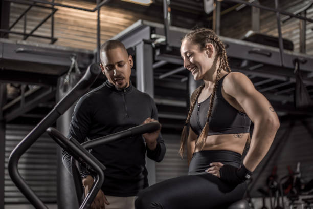 istock Female fighter and male coach during a workout 1155608288