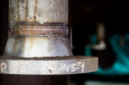 Weld joint of nozzle in pressure vessel is carbon steel,  included Flange and Nozzle Neck, Assembly in factory, background.