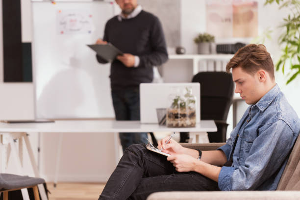 istock Professional psychologist and teenager explaining his problems during therapy 1155610007