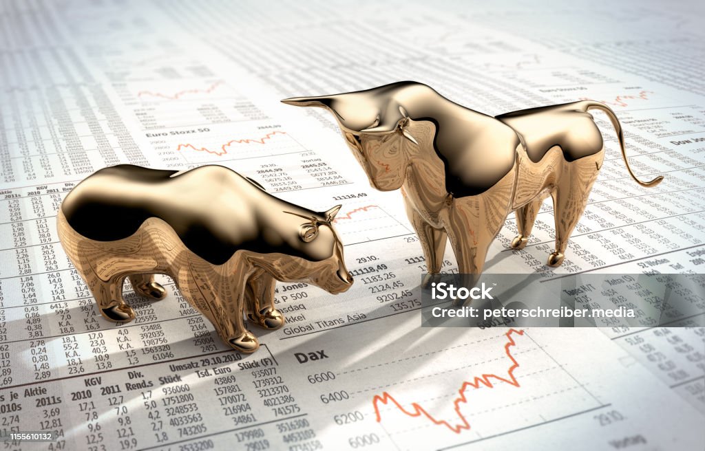 Bull and Bear on stock market prices Golden symbolic figures on Finanzzeitung Stock Market and Exchange Stock Photo
