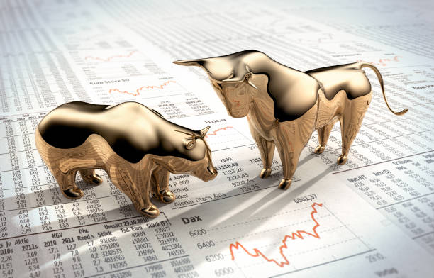 Bull and Bear on stock market prices Golden symbolic figures on Finanzzeitung stock certificate photos stock pictures, royalty-free photos & images