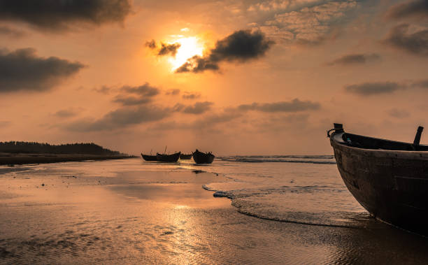 Silhouette Boats Silhouette Boats anchored on the sea Beach at Digha beach. fishing village photos stock pictures, royalty-free photos & images