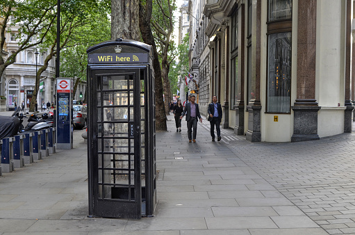 London, United Kingdom, 14 June 2018. London's telephone booths are one of the symbols of the city. Classically strictly red. More rarely in black with the WiFi logo in evidence.