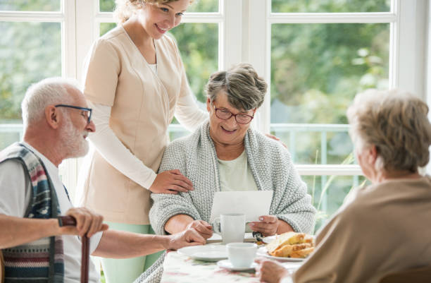 istock Senior friends spending time together at nursing home 1155615976