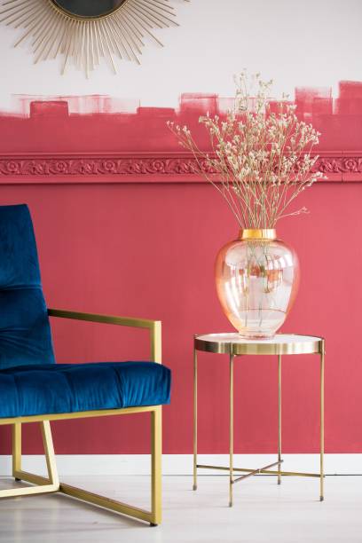 istock Blue settee next to small elegant table with glass vase with dry flowers 1155616115