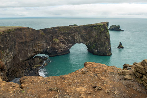 istock Dyrholaey rock arch in the Atlantic ocean, Iceland 1155617261