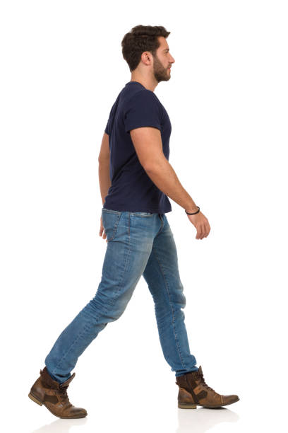 istock Walking Man In Blue T-shirt, Jeans And Boots 1155617870