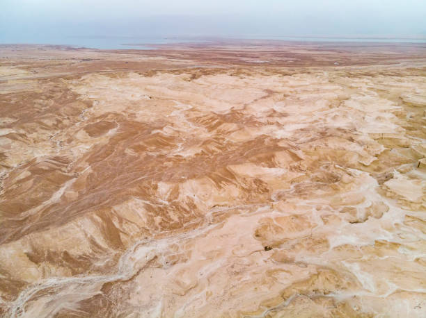 intriguing and picturesque landscape of the judean desert located on the west bank of jordan river. aerial view of terracotta desert in israel that lies east of jerusalem and descends to dead sea. - travel jordan israel sand imagens e fotografias de stock