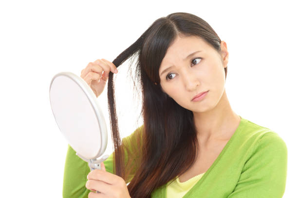istock Woman looking at her face with hand mirror 1155620201
