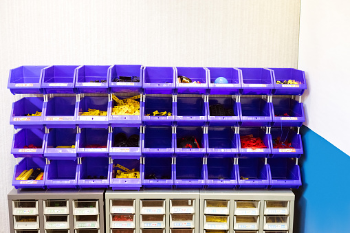 Various plastic blocks on rack. Equipment arranged in STEM class at programming school.