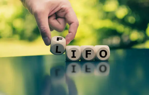 Hand turns a cube and changes the expression "FIFO" (first in, first out) to "LIFO" (last in, first out) or vice versa.