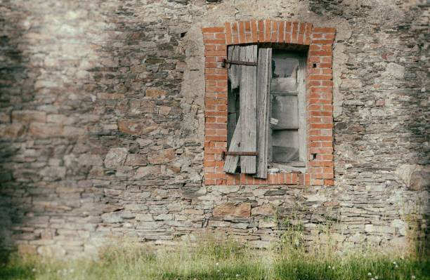 Old house. Architecture of old Europe. The shabby wall of the house. Wooden shutters. Windows and doors. View from the street. Camino de Santiago. The Way of St. James.