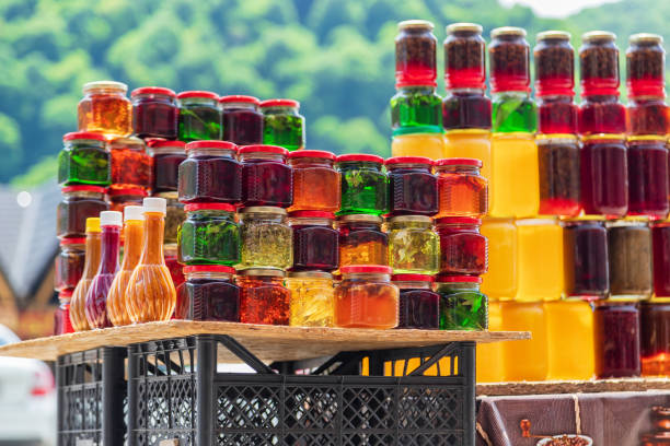 istock Small colorful glass jars with jam from local berries, herbs, roots and nuts 1155624031