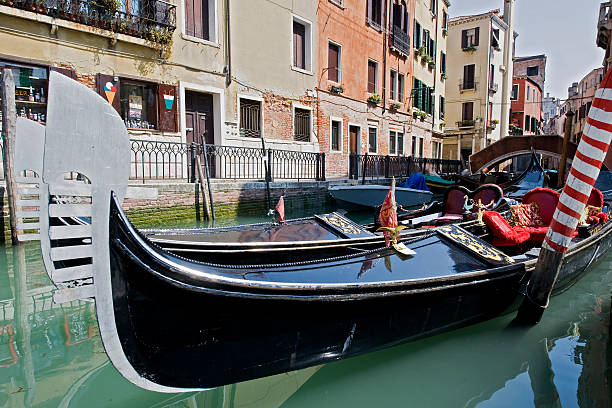 istock Gondolas in a small canal of Venice, Italy 115562479