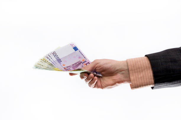istock Man in suit offering euro banknotes isolated on white 1155628999