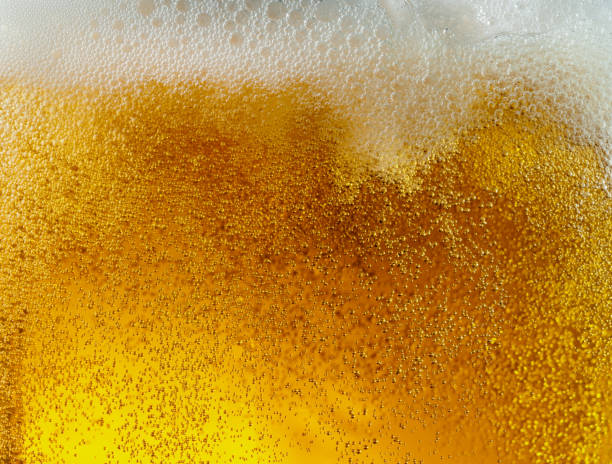 istock Close up view of floating bubbles in light beer texture 1155631632