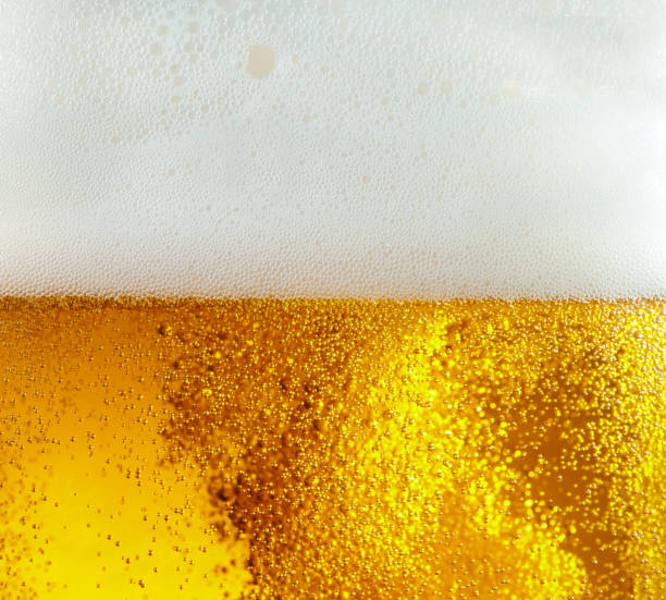 istock Close up view of floating bubbles in light beer texture 1155631635