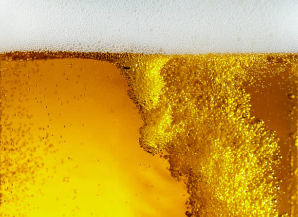 istock Close up view of floating bubbles in light beer texture 1155631642