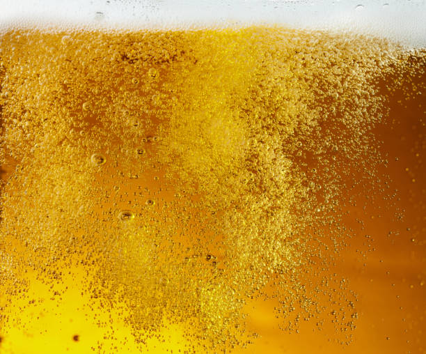 istock Close up view of floating bubbles in light beer texture 1155631645