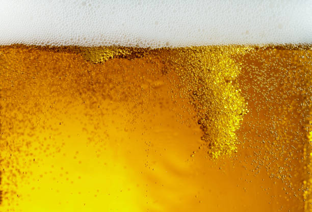 istock Close up view of floating bubbles in light beer texture 1155631651