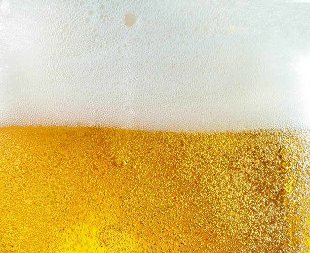 istock Close up view of floating bubbles in light beer texture 1155631680