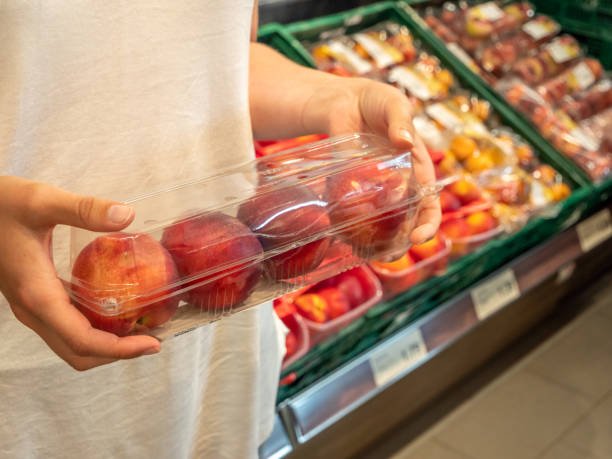 istock Peach in a plastic wrapper in the supermarket 1155633660