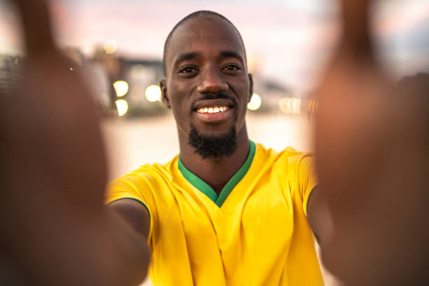 istock Smiling black man taking a selfie at the beach 1155635666
