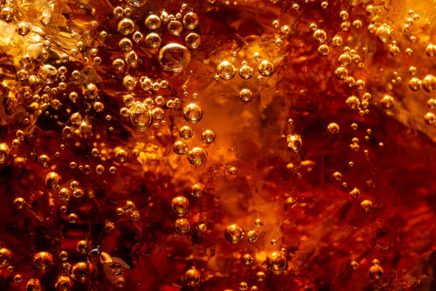 Detail of Cold Bubbly Carbonated Soft Drink with Ice Bubble, Carbonated, Cola, Drink, Fruit soda pop stock pictures, royalty-free photos & images