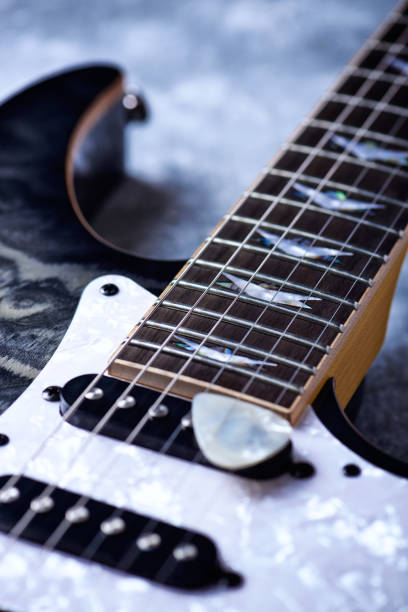 istock Electric guitar close up. Wooden background. 1155637053