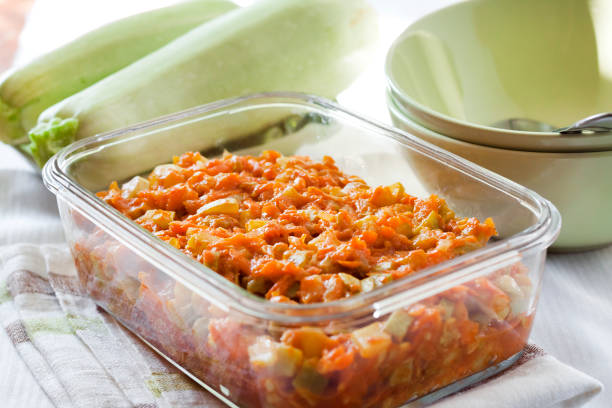 istock Squash stew with carrot and tomatoes in a square glass dish 1155637688