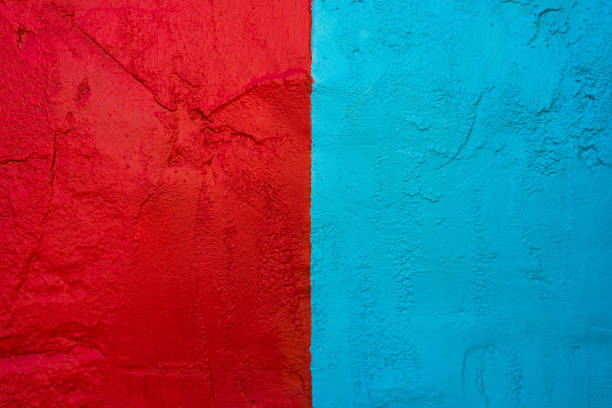 Textured wall painted in red and turquoise bright and contrasting colors
