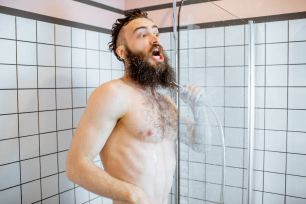 istock Man takign a shower with cold water 1155640661