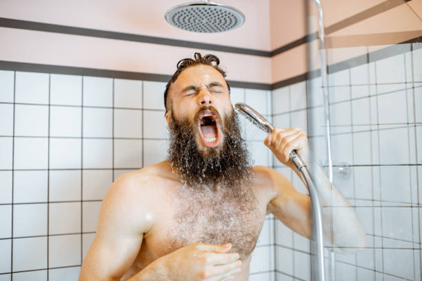istock Man takign a shower with cold water 1155640698