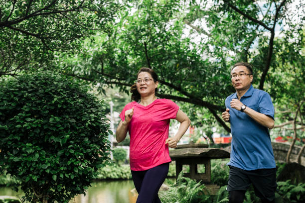 istock Senior couple jogging at park 1155641399
