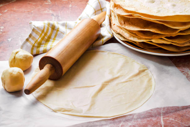 istock Cooking cake Napoleon - baked cake layers, raw dough and rolling pin 1155641547