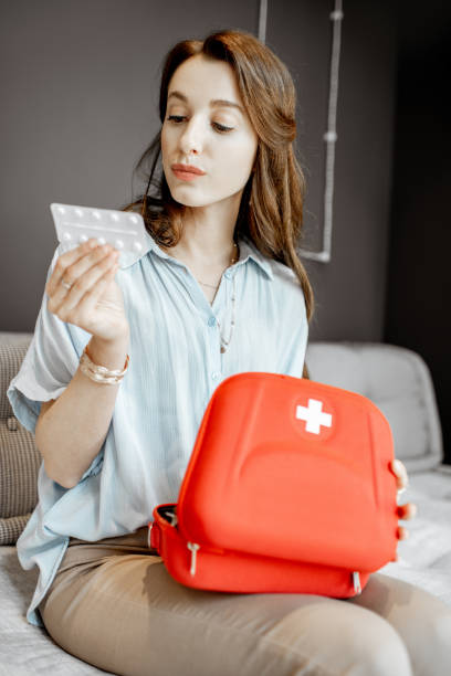 istock Sad woman with medicines at home 1155641653