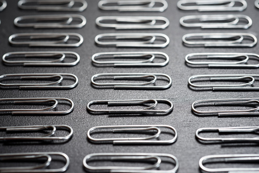 Clips. Office supplies for office work. Lots of paper clips on a white background.