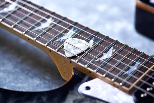 istock Electric guitar close up. Wooden background. 1155644015