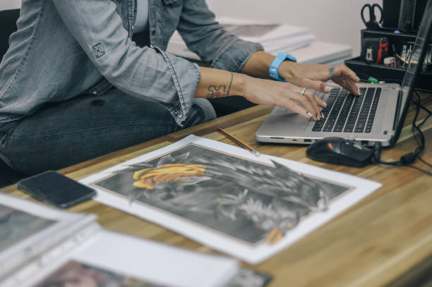 istock Female tattoo artist working in tattoo studio 1155647931
