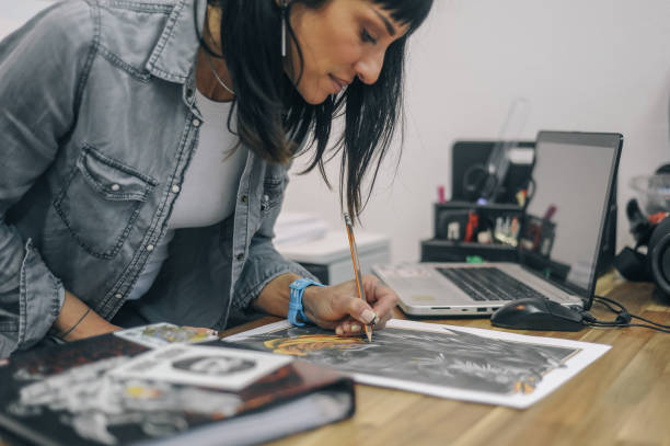 istock Female tattoo artist working in tattoo studio 1155647958