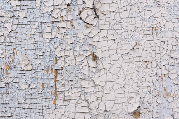 istock Texture of peeling white paint on a wooden wall. Surface with worn material. 1155648127